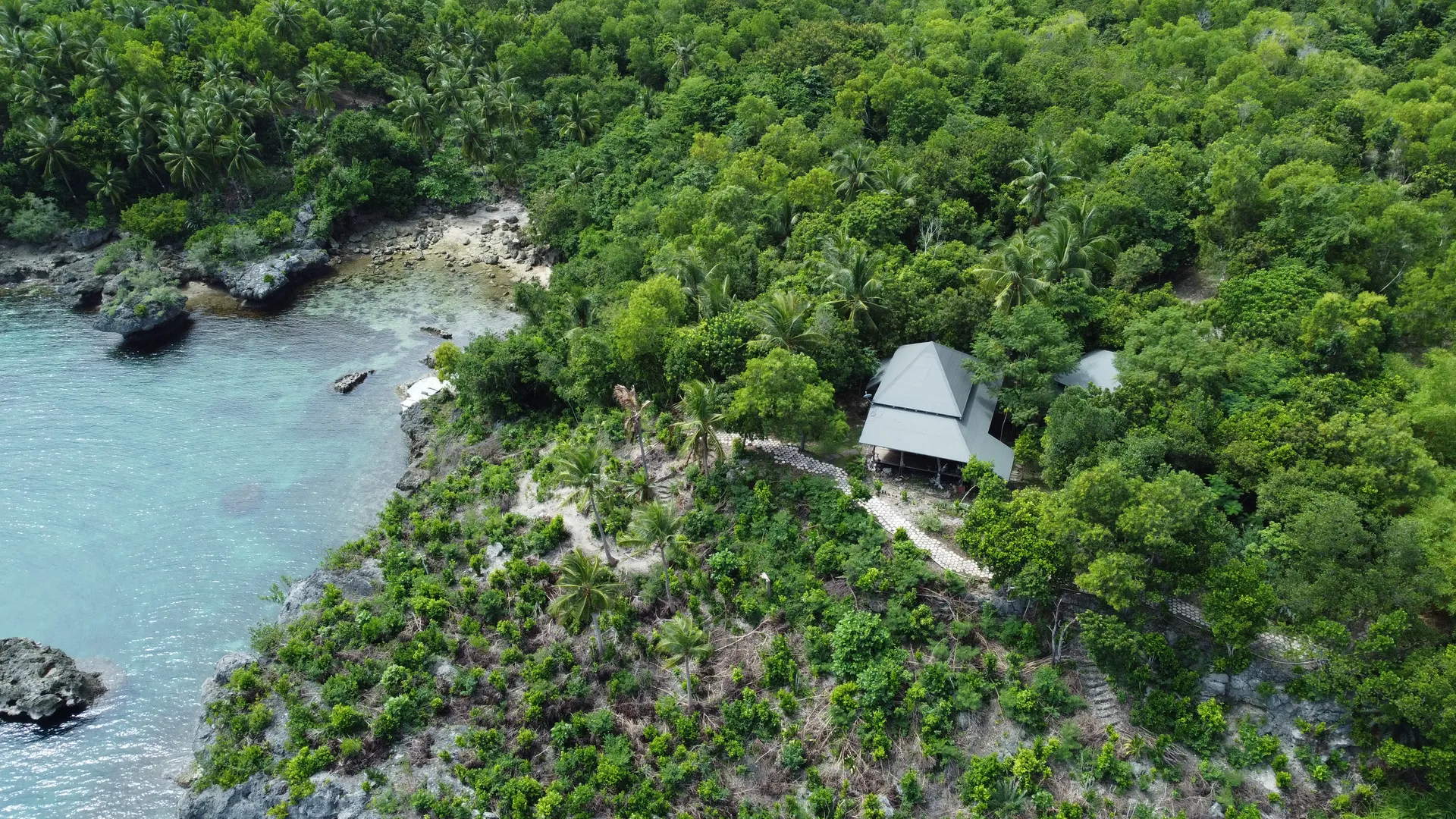Aerial view of the estate nestled in dense tropical greenery beside the Visayan Sea